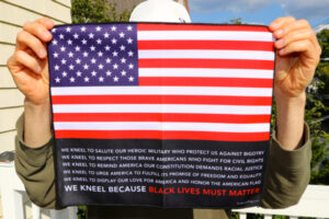 The Black Lives Must Matter Flag held up to the camera